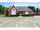 Community building featuring brick facade, mature landscaping, and ample parking at 4011 Charrwood Trce, Marietta, GA 30062