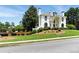 Beautiful landscaped front yard with a luxurious white home in the background at 4011 Charrwood Trce, Marietta, GA 30062