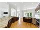Bright kitchen boasts granite countertops, stainless steel appliances, custom cabinetry, and seamless access to other rooms at 4011 Charrwood Trce, Marietta, GA 30062