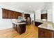 Gourmet kitchen featuring granite countertops, stainless steel appliances, dark wood cabinetry, and hardwood flooring at 4011 Charrwood Trce, Marietta, GA 30062