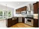 Gourmet kitchen featuring stainless steel appliances, granite countertops, and a large window at 4011 Charrwood Trce, Marietta, GA 30062