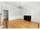Elegant living room featuring hardwood floors, a fireplace, and modern lighting fixture at 4011 Charrwood Trce, Marietta, GA 30062