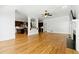 Open-concept living area with hardwood floors, fireplace, and seamless access to kitchen at 4011 Charrwood Trce, Marietta, GA 30062