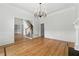 Elegant living room featuring hardwood floors, a fireplace, and modern lighting fixture at 4011 Charrwood Trce, Marietta, GA 30062