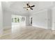 Bright main bedroom featuring a tray ceiling, ceiling fan, and adjacent room at 4011 Charrwood Trce, Marietta, GA 30062