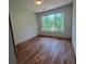 Well-lit bedroom features a neutral color palette, hardwood floors, and a window offering a bright view at 4107 Danforth Sw Rd, Atlanta, GA 30331