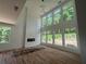 Bright, spacious living room with large windows, hardwood floors, fireplace, and soaring vaulted ceiling at 4107 Danforth Sw Rd, Atlanta, GA 30331