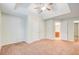 Spacious bedroom with large closets, neutral carpet, ceiling fan, and access to bathroom at 414 Pamela Ct, Mcdonough, GA 30252
