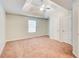 Large carpeted bedroom featuring a ceiling fan and closet doors at 414 Pamela Ct, Mcdonough, GA 30252