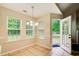Bright breakfast nook features tile floors, three windows, and an outdoor view through the open patio door at 414 Pamela Ct, Mcdonough, GA 30252
