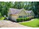 Exterior shot of the home and its garage, complemented by lush greenery and a driveway at 414 Pamela Ct, Mcdonough, GA 30252