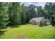 A large home with a well-manicured lawn and mature trees that provide privacy and shade at 414 Pamela Ct, Mcdonough, GA 30252