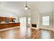 Bright living room showcasing a fireplace, hardwood floors, and an open layout to the kitchen at 414 Pamela Ct, Mcdonough, GA 30252