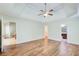 Spacious main bedroom featuring hardwood floors, a ceiling fan, and a tray ceiling at 414 Pamela Ct, Mcdonough, GA 30252