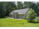 Single-Gathering home has a well-maintained yard, a deck, a patio, and mature trees in the background at 414 Pamela Ct, Mcdonough, GA 30252
