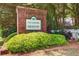 A brick sign that reads 'The Landing at Meadow Trace' with green foliage at 414 Pamela Ct, Mcdonough, GA 30252