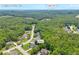 An aerial view of a Loganville, GA neighborhood with mature trees and well-maintained homes near Hwy 78 at 1213 Fairwinds Dr, Loganville, GA 30052