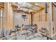 Unfinished basement with exposed beams, and workout area with free weights and punching bag at 1213 Fairwinds Dr, Loganville, GA 30052