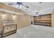 Unfinished basement featuring concrete floors, a jukebox, wood paneling, and industrial lighting at 1213 Fairwinds Dr, Loganville, GA 30052