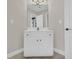 Bathroom features a white vanity with cabinet storage, stylish lighting, and tiled flooring at 1213 Fairwinds Dr, Loganville, GA 30052