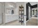 A spacious bathroom with a double vanity, storage tower and decorative tile flooring at 1213 Fairwinds Dr, Loganville, GA 30052
