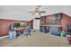Bonus room includes a ceiling fan, custom workspace, and neutral carpeting at 1213 Fairwinds Dr, Loganville, GA 30052