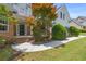 Welcoming home with brick accents, manicured shrubs, and a concrete walkway leading to the covered front porch at 1213 Fairwinds Dr, Loganville, GA 30052