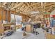 A large, unfinished garage space for workshop or storage with multiple workbenches and window at 1213 Fairwinds Dr, Loganville, GA 30052