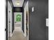Hallway view leads to the bathroom, showcasing the tub next to a large window at 1213 Fairwinds Dr, Loganville, GA 30052