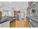 Kitchen features granite countertops, stainless steel appliances, wooden cabinets and hardwood floors at 1213 Fairwinds Dr, Loganville, GA 30052