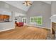 Spacious living room flows into kitchen and dining areas, featuring hardwood floors and ample natural light at 1213 Fairwinds Dr, Loganville, GA 30052