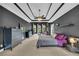 Large bedroom with dark-painted walls, bright white tray ceiling, neutral carpeting and generous natural light at 1213 Fairwinds Dr, Loganville, GA 30052