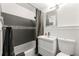 Modern bathroom with gray tile, shower curtain, contemporary sink and toilet, and nice fixtures at 215 Piedmont Ne Ave # 303, Atlanta, GA 30308
