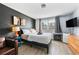 Modern bedroom featuring a full bed, dark accent wall, and a TV at 215 Piedmont Ne Ave # 303, Atlanta, GA 30308