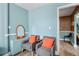 Sitting area with matching chairs, orange pillows and trim, and a view to the hallway at 215 Piedmont Ne Ave # 303, Atlanta, GA 30308