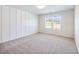Well-lit bedroom featuring modern wall paneling and large window showcasing scenic outdoor views at 4377 Hosch Reserve Dr, Buford, GA 30519