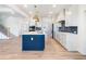 Modern kitchen with stainless steel appliances and a navy island with white countertop at 4377 Hosch Reserve Dr, Buford, GA 30519