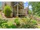 Multi-tiered backyard with a covered deck and lush landscaping, creating a private outdoor retreat at 580 Washington Way, Cumming, GA 30040