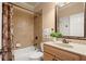 Cozy bathroom includes a shower-tub combo with neutral tile, a vanity, and decorative accents at 580 Washington Way, Cumming, GA 30040