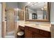 Bathroom featuring a glass-enclosed shower, marble countertops, and a large mirror at 580 Washington Way, Cumming, GA 30040