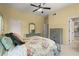 A bedroom features a bed, dresser, and entrance to another room as well as a ceiling fan at 580 Washington Way, Cumming, GA 30040