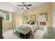 A bedroom shows a bed, sitting bench, windows with curtains, and ceiling fan at 580 Washington Way, Cumming, GA 30040