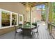 Inviting deck space featuring an outdoor dining set, with string lights creating a cozy ambiance at 580 Washington Way, Cumming, GA 30040