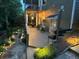Inviting outdoor deck space featuring ambient lighting, a grill, and picturesque landscaping in the backyard at 580 Washington Way, Cumming, GA 30040