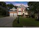 Well-maintained brick home showcasing a manicured front lawn, a two-car garage, and charming curb appeal at 580 Washington Way, Cumming, GA 30040