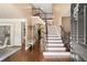 The foyer has hardwood flooring and features a staircase and entry to other rooms in the home at 580 Washington Way, Cumming, GA 30040
