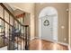 The foyer features hardwood flooring and an arched doorway and a view into another room at 580 Washington Way, Cumming, GA 30040