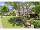 Brick two-story home with a well-manicured lawn, two-car garage and a classic architectural style at 580 Washington Way, Cumming, GA 30040