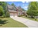 Brick two-story home with a well-manicured lawn, two-car garage and a classic architectural style at 580 Washington Way, Cumming, GA 30040