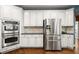 Spacious kitchen equipped with stainless steel appliances, double ovens, and ample cabinet space at 580 Washington Way, Cumming, GA 30040